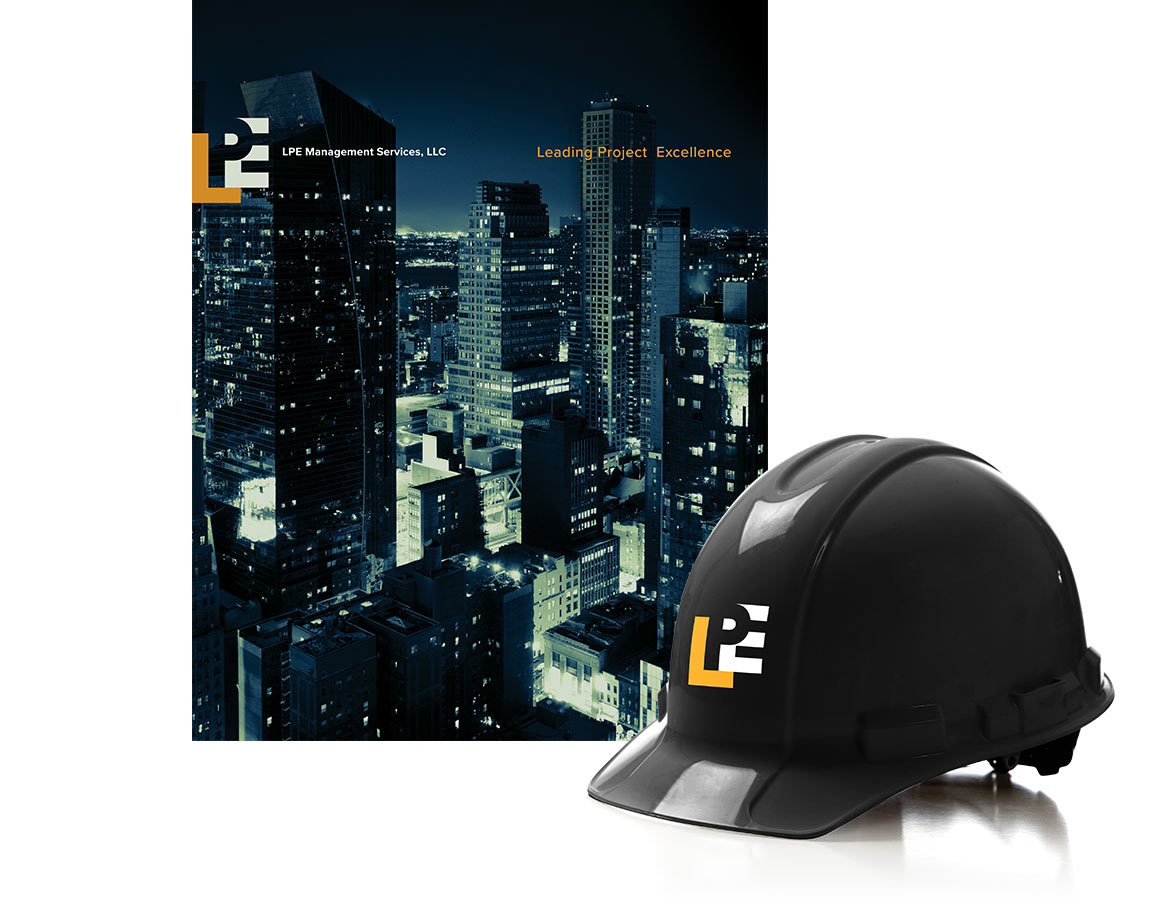 The LPE Management Services brand identity designed by Bernhardt Fudyma Design Group NY applied to a marketing capabilities brochure and hard hat