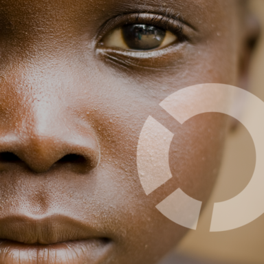 Graphic element of the Missio Invest logo placed on a closeup of an African child’s image.